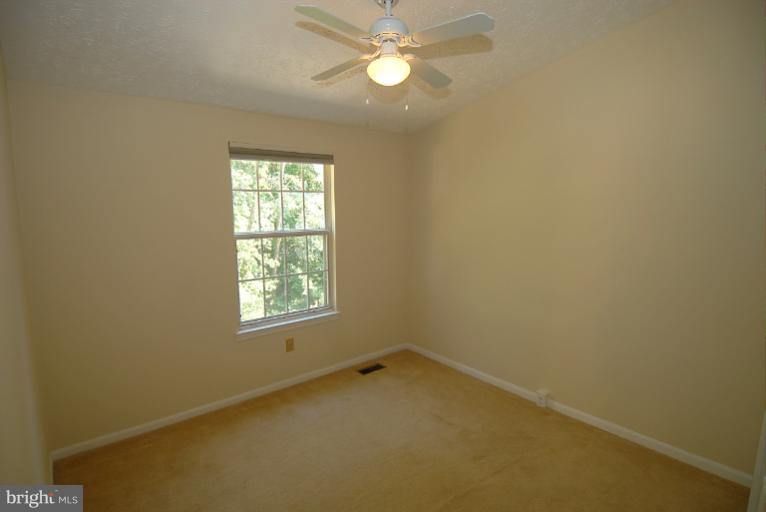 1489 Autumn Ridge Circle Reston, VA 20194 - Photo 16 of 23 an empty room with a window and a fan