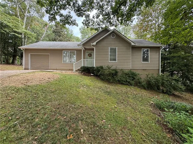 a front view of house with yard and trees