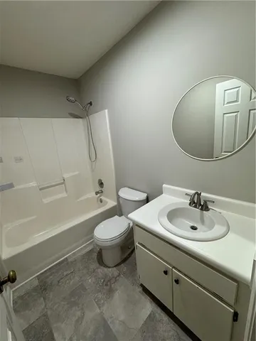 a bathroom with a sink a toilet and bathtub