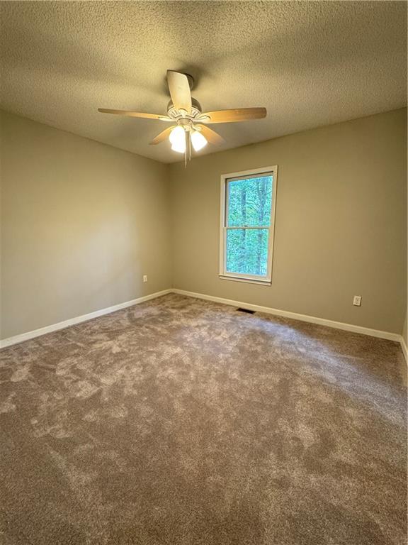 71 Emerald Lane Jasper, GA 30143 - Photo 15 of 30 an empty room with a window and a fan