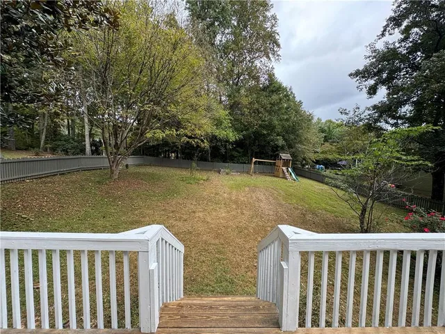 a view of a wooden deck with a yard