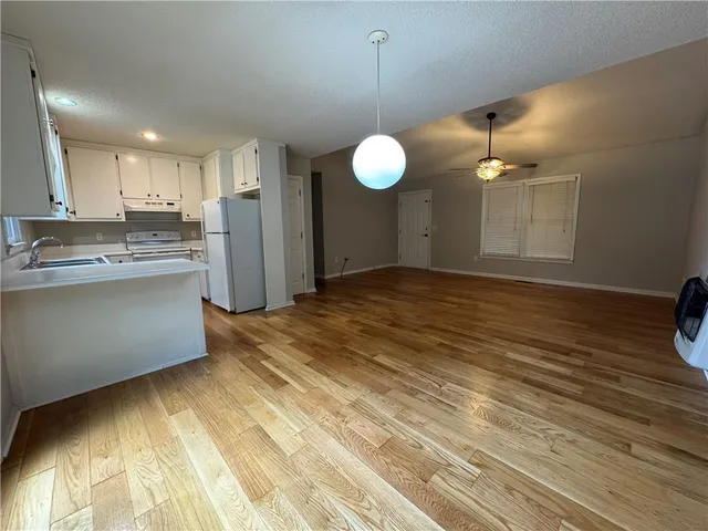 a view of a kitchen with a sink and cabinets