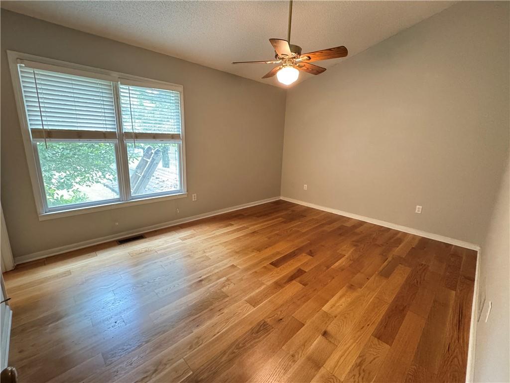 71 Emerald Lane Jasper, GA 30143 - Photo 9 of 30 an empty room with wooden floor fan and windows