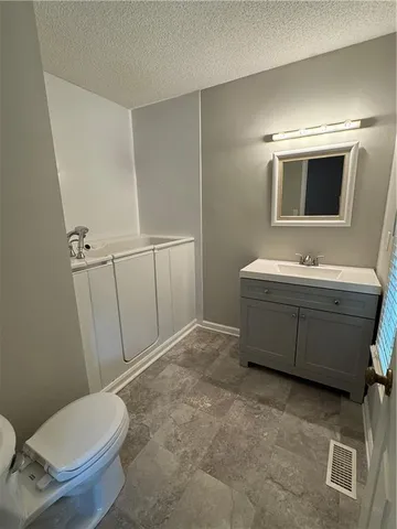 a bathroom with a toilet sink and mirror