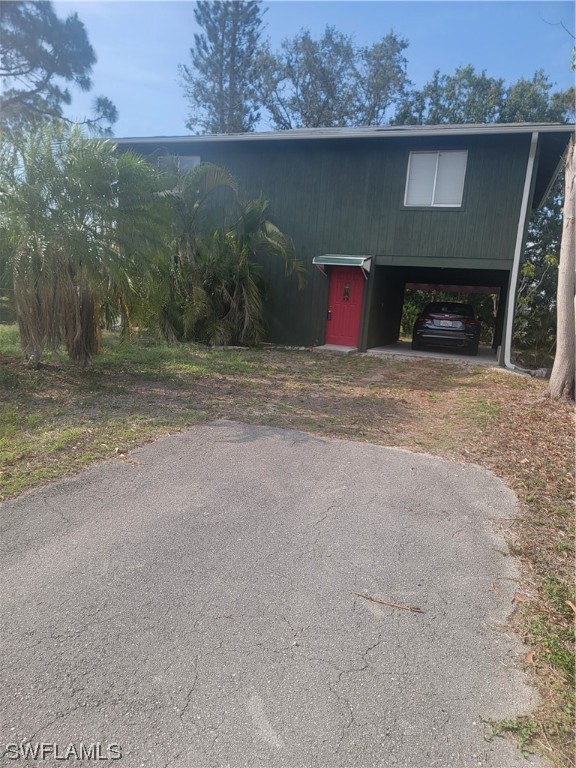 8469 Cardinal Road Fort Myers, FL 33967 - Photo 1 of 44 a front view of a house with yard