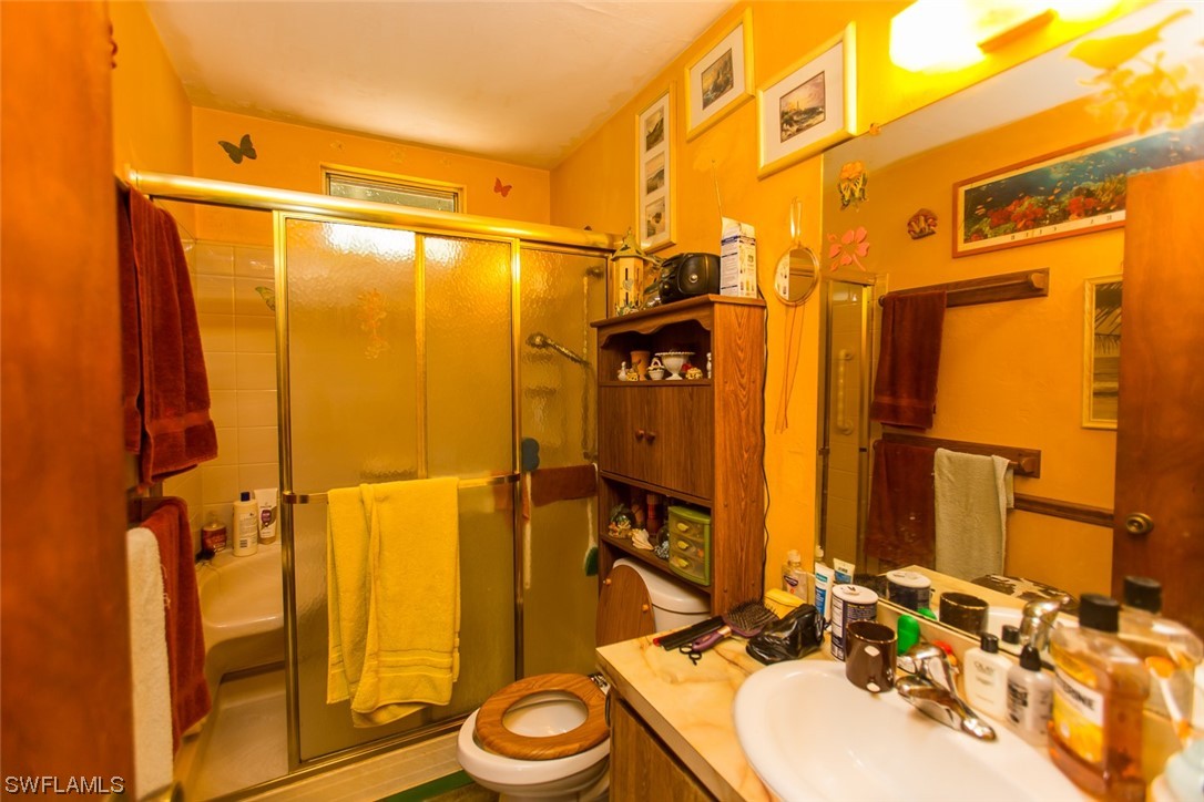 8469 Cardinal Road Fort Myers, FL 33967 - Photo 23 of 44 a bathroom with a sink and a mirror