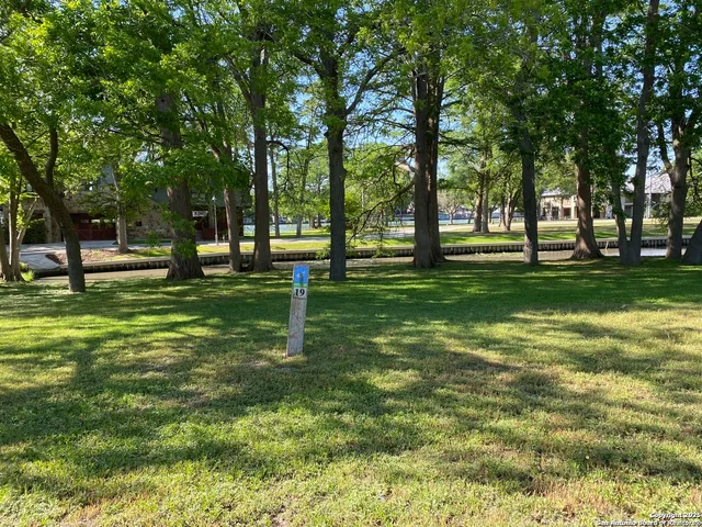 a view of a park with trees in the background