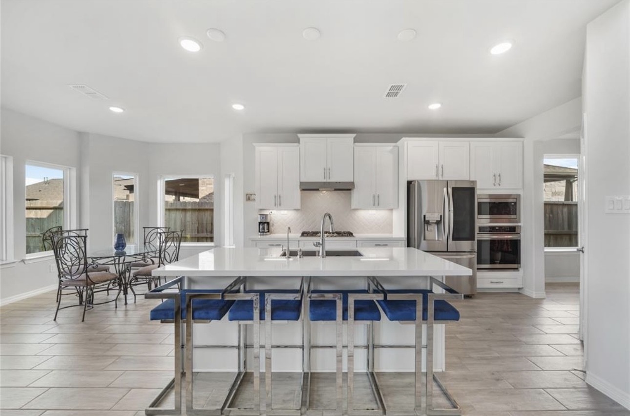 1711 Country Air Lane Missouri City, TX 77459 - Photo 13 of 29 a large kitchen with a table and chairs