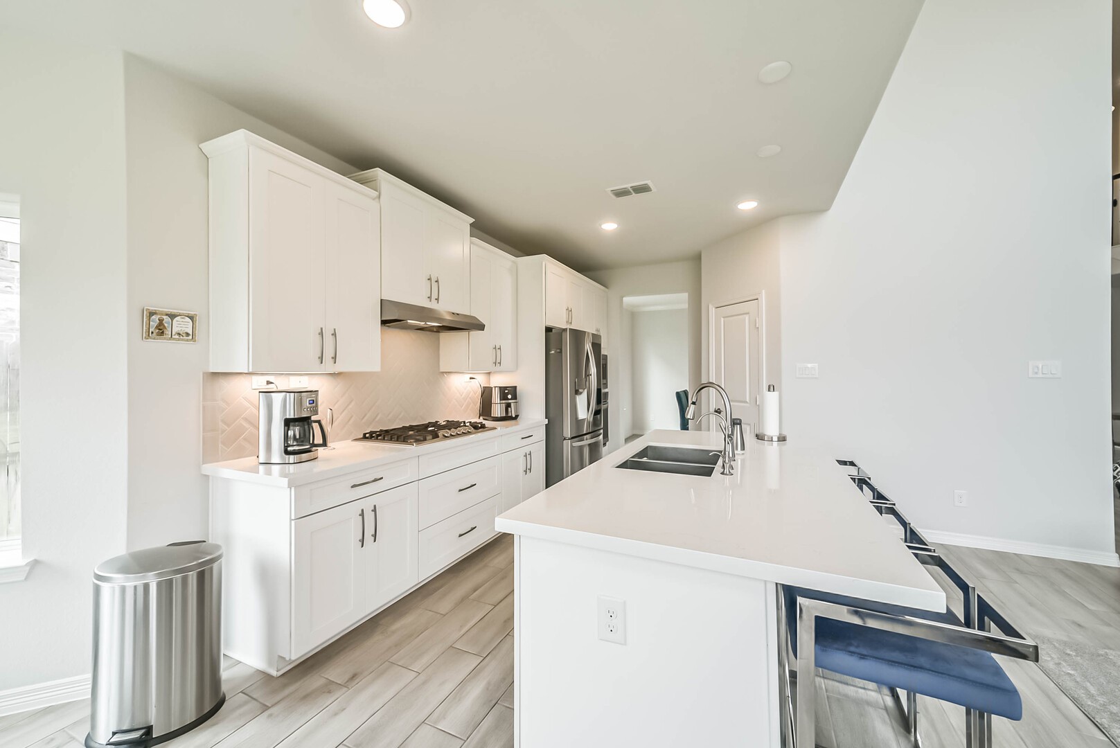 1711 Country Air Lane Missouri City, TX 77459 - Photo 14 of 29 a kitchen with stainless steel appliances a sink stove and cabinets