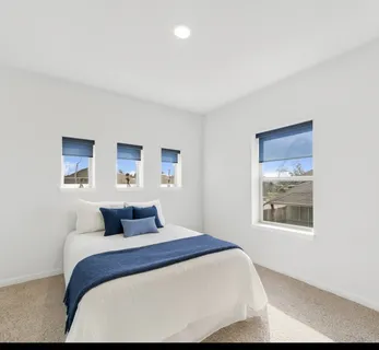 a bedroom with a large bed and a window