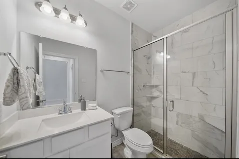 a bathroom with a sink toilet and shower