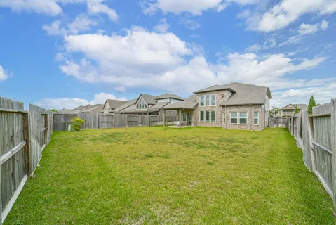 a front view of house with a garden
