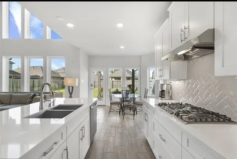 a kitchen with stainless steel appliances granite countertop a lot of counter space and a sink