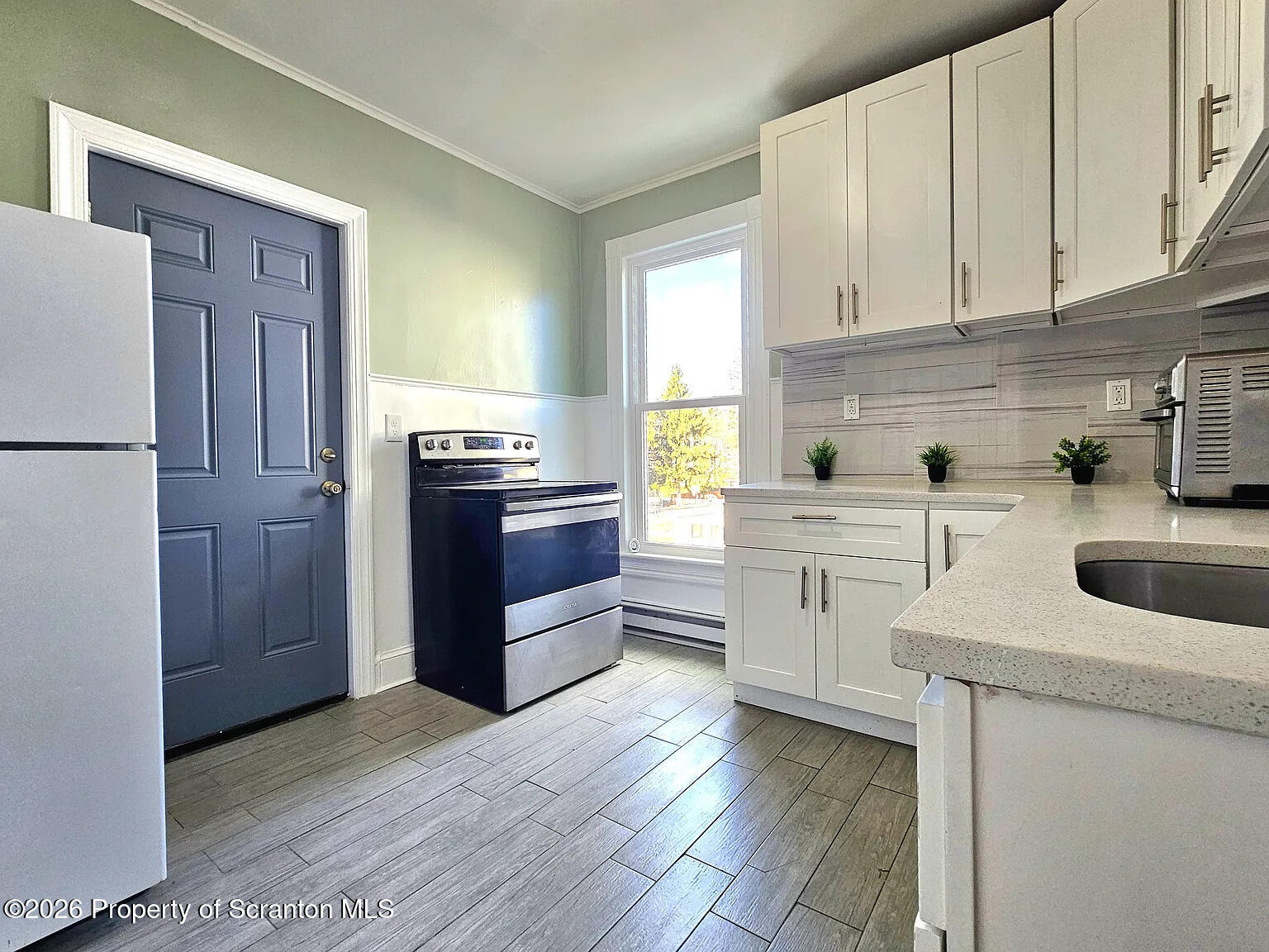 1615 Monsey Avenue Scranton, PA 18509 - Photo 6 of 10 a kitchen with stainless steel appliances granite countertop a sink stove and refrigerator