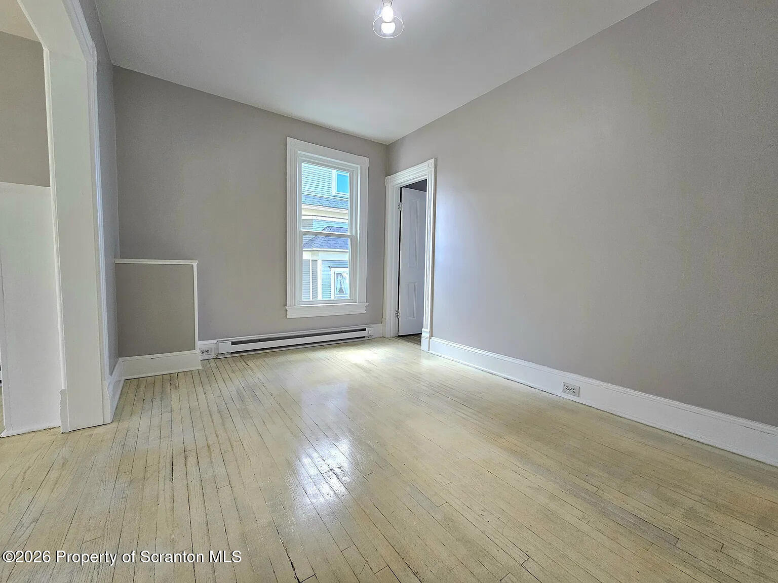 1615 Monsey Avenue Scranton, PA 18509 - Photo 8 of 10 an empty room with wooden floor and windows