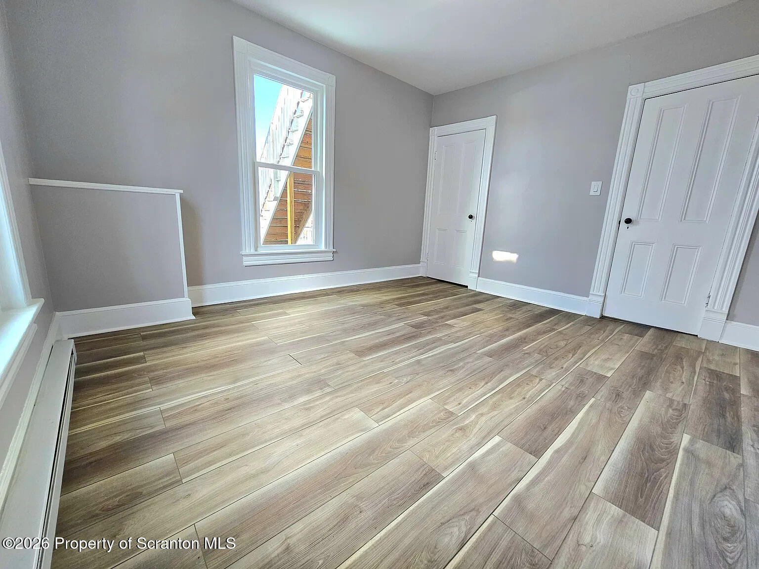 1615 Monsey Avenue Scranton, PA 18509 - Photo 9 of 10 a view of an empty room with wooden floor and a window