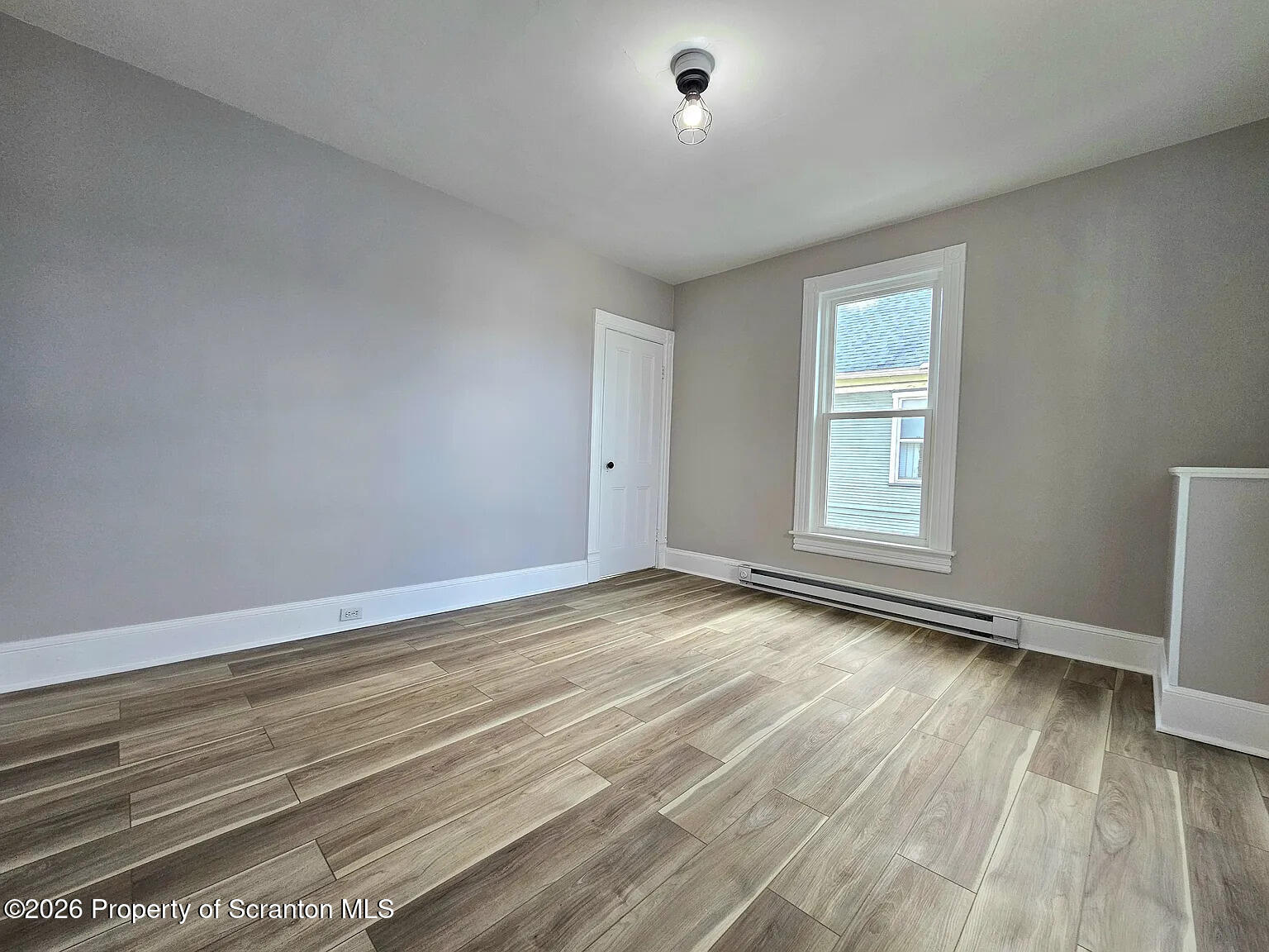 1615 Monsey Avenue Scranton, PA 18509 - Photo 10 of 10 a view of empty room with wooden floor and fan