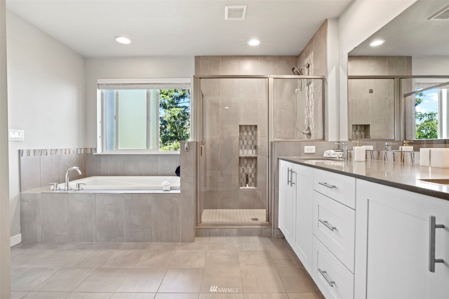 1325 Seattle Hill Road, Unit F1 Bothell, WA 98012 - Photo 23 of 34 a spacious bathroom with a double vanity sink a bathtub and a shower