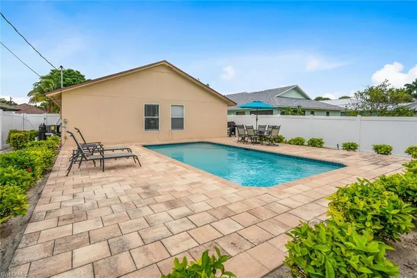 a view of a house with a yard and sitting area