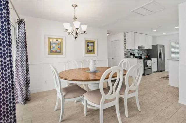 a view of a dining room with furniture and chandelier