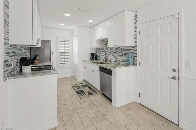a kitchen with stainless steel appliances granite countertop a stove and a refrigerator