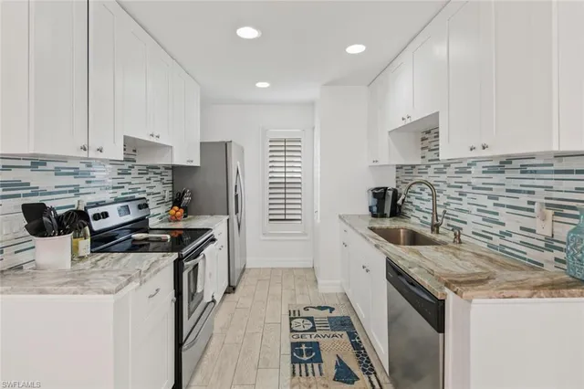 a kitchen with stainless steel appliances granite countertop a stove and a sink