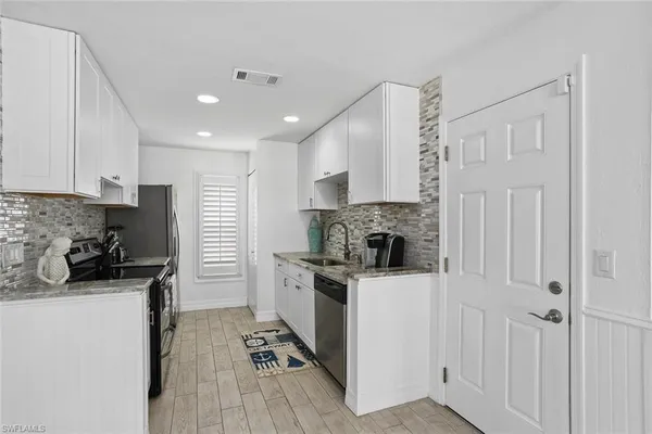 a kitchen with a sink a stove and refrigerator