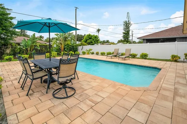 a view of swimming pool with outdoor seating