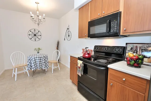 a dining room with furniture and a chandelier