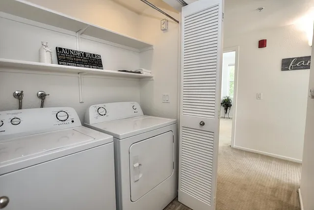 a bathroom with a toilet a sink a mirror a bathtub and vanity