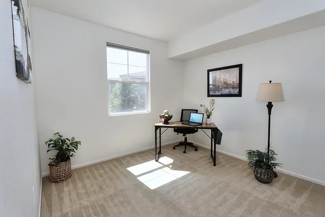 a work room with furniture and a window