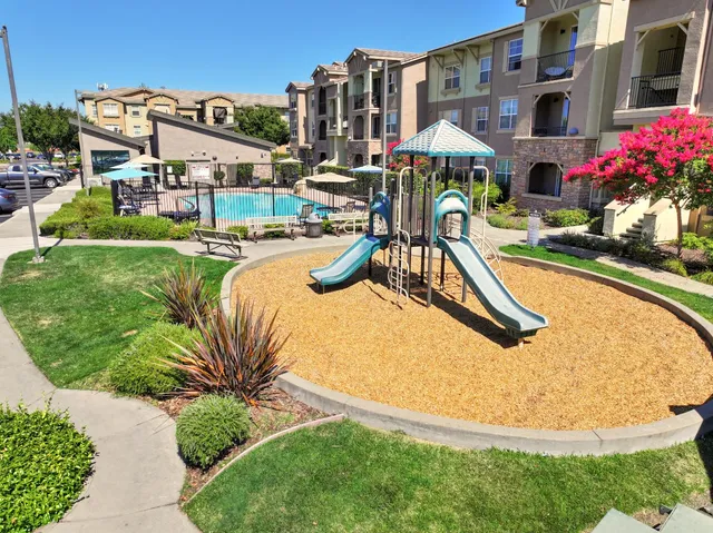 a view of a patio with a table and chairs under an umbrella