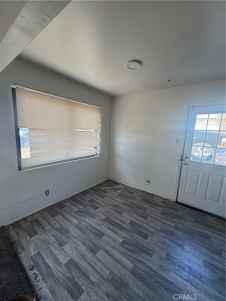 1901 Sunrise Road Barstow, CA 92311 - Photo 3 of 10 an empty room with wooden floor and windows