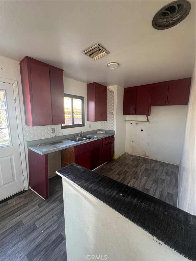 1901 Sunrise Road Barstow, CA 92311 - Photo 4 of 10 a kitchen with kitchen island granite countertop wooden cabinets a stove and a sink