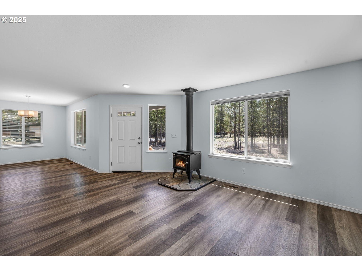 11421 Burlwood Road La Pine, OR 97739 - Photo 4 of 31 a view of an empty room with wooden floor and a window