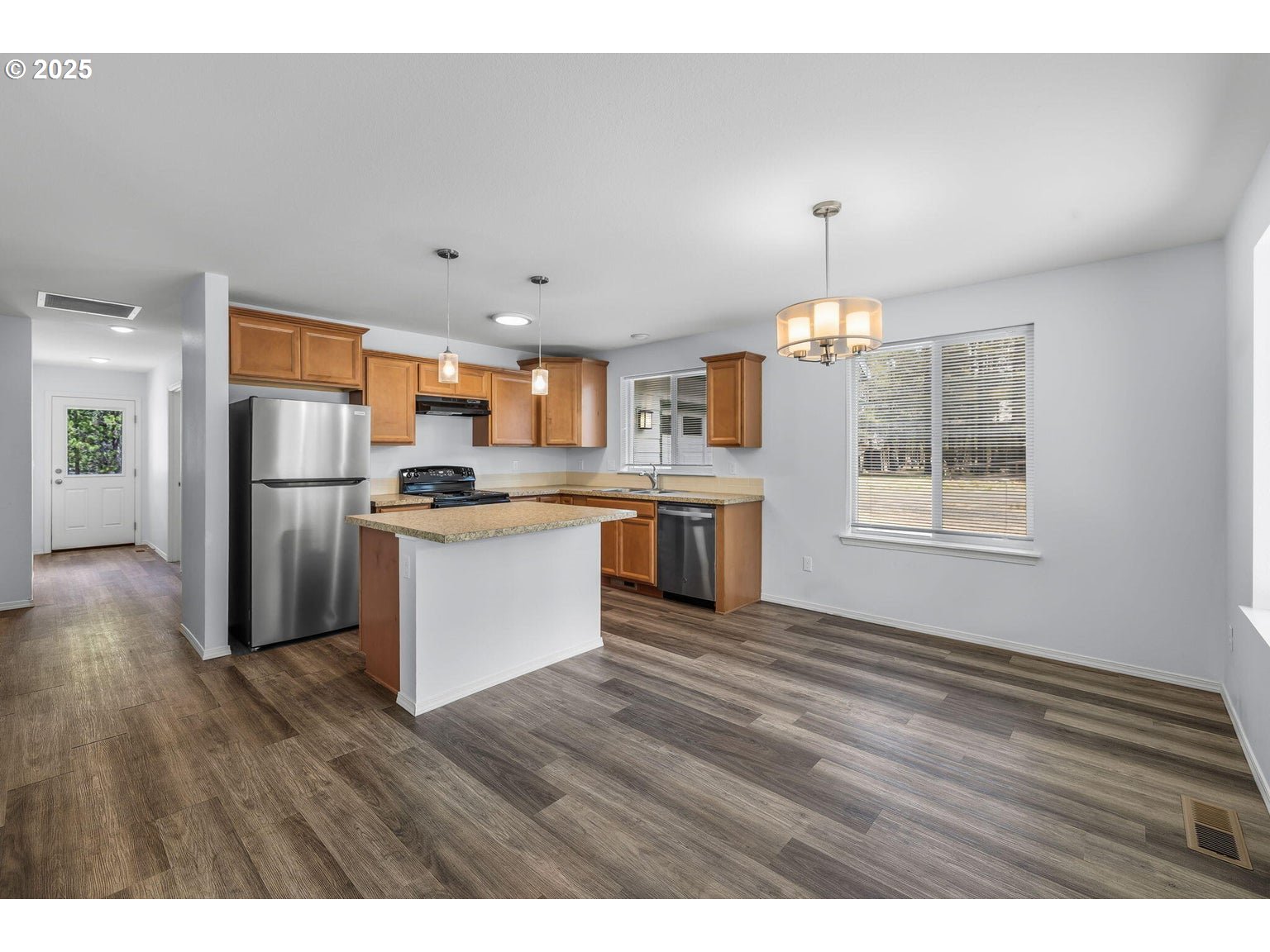 11421 Burlwood Road La Pine, OR 97739 - Photo 5 of 31 a kitchen with stainless steel appliances kitchen island granite countertop a refrigerator stove top oven and cabinets