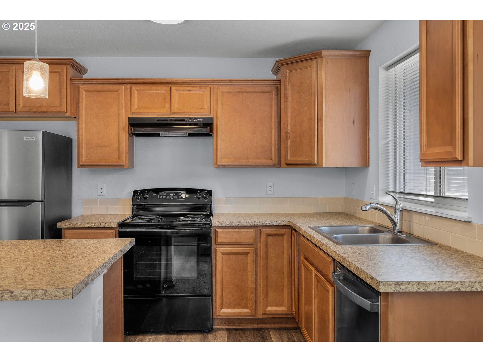 11421 Burlwood Road La Pine, OR 97739 - Photo 7 of 31 a kitchen with a sink a stove and cabinets