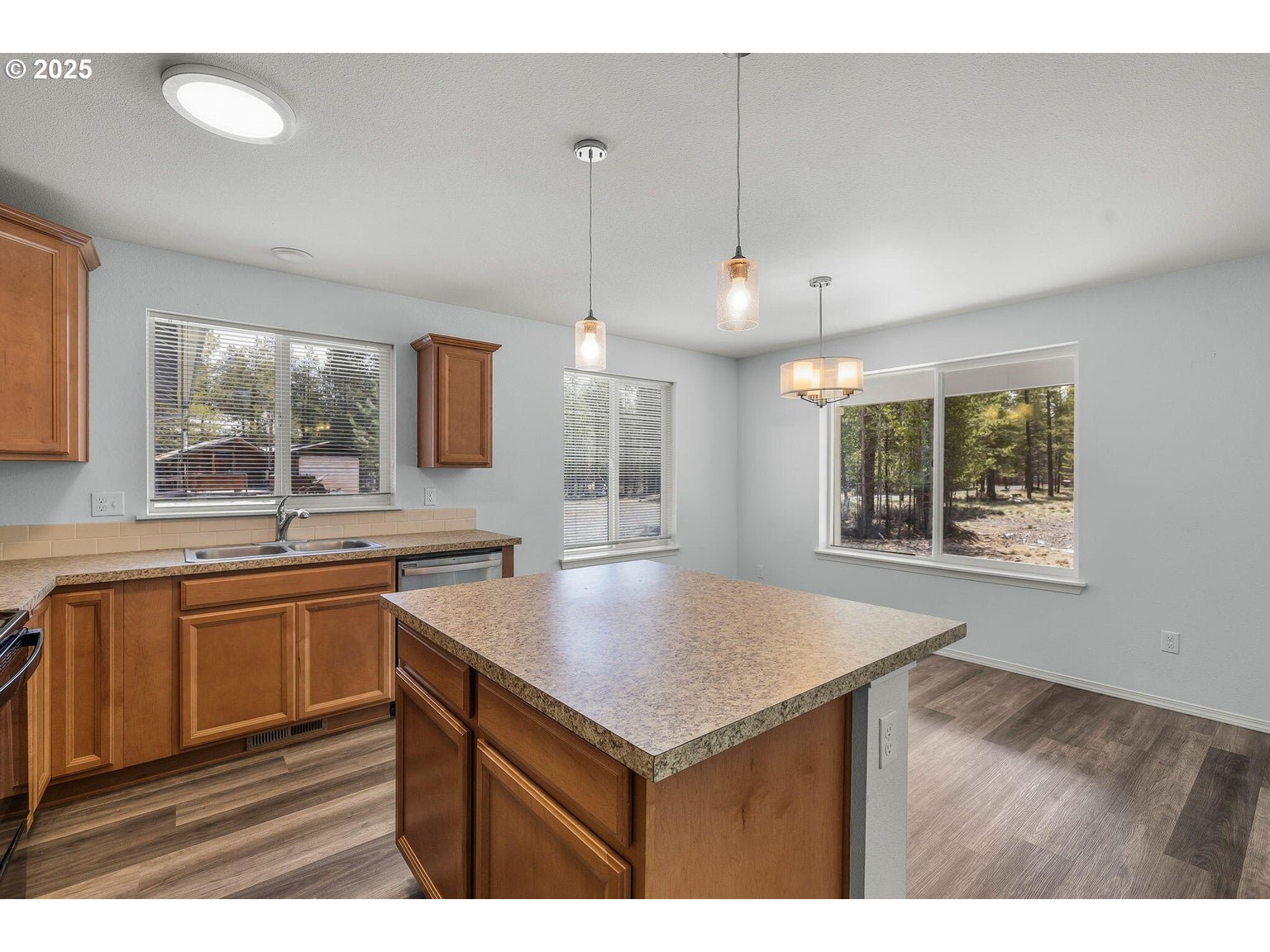 11421 Burlwood Road La Pine, OR 97739 - Photo 8 of 31 a kitchen with a sink a counter top space and living room
