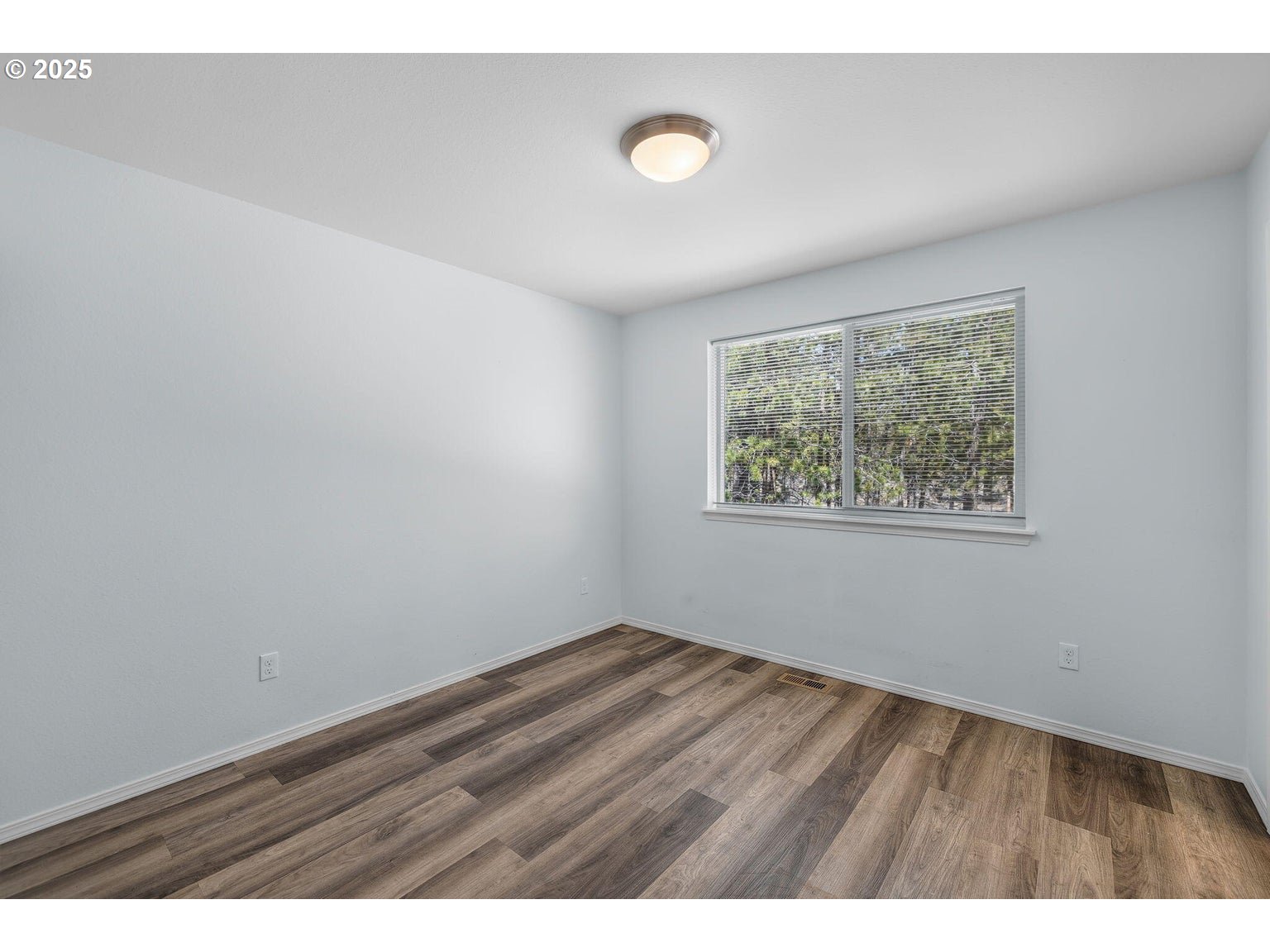 11421 Burlwood Road La Pine, OR 97739 - Photo 10 of 31 a view of an empty room with wooden floor