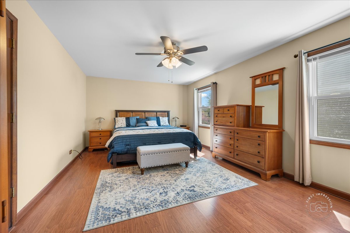 375 Hunter Drive Carol Stream, IL 60188 - Photo 14 of 20 a bedroom with a bed and wooden floor