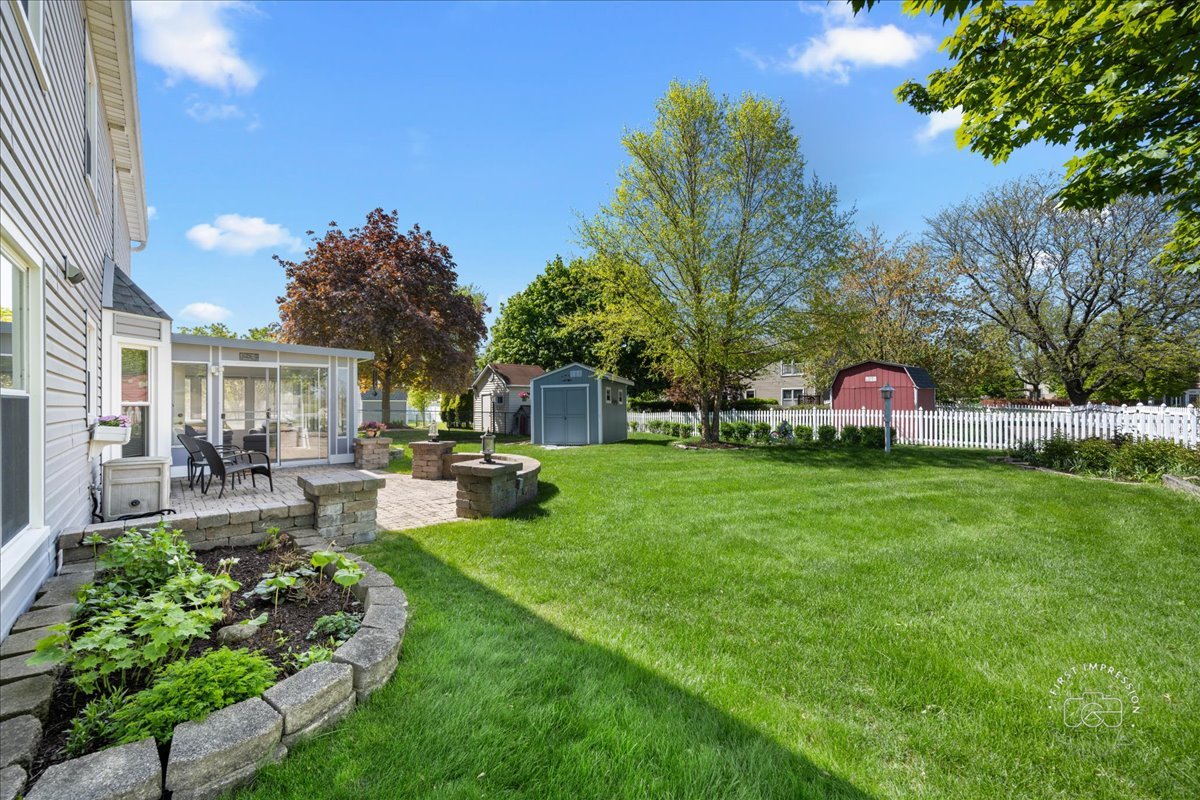 375 Hunter Drive Carol Stream, IL 60188 - Photo 2 of 20 a front view of a house with garden and sitting area