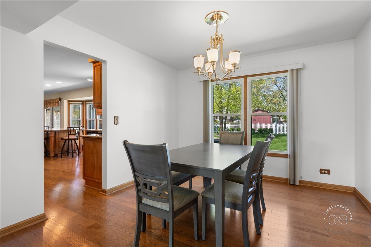 375 Hunter Drive Carol Stream, IL 60188 - Photo 10 of 20 a view of a dining room with furniture window and wooden floor