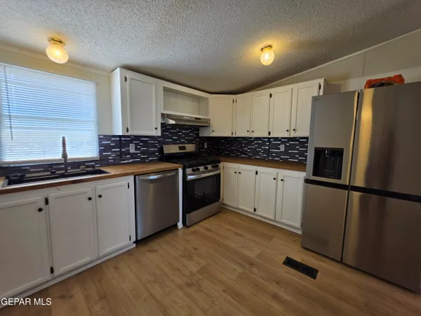 a spacious bathroom with a granite countertop tub sink and shower