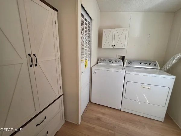 a bathroom with a toilet sink vanity and mirror
