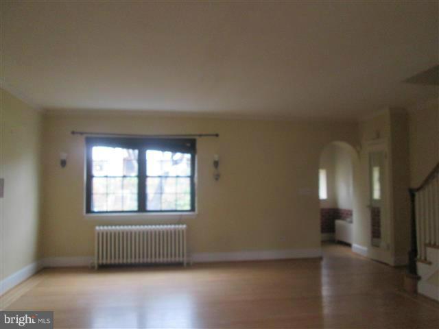 3711 Rexmere Road Baltimore, MD 21218 - Photo 4 of 23 an empty room with wooden floor and windows