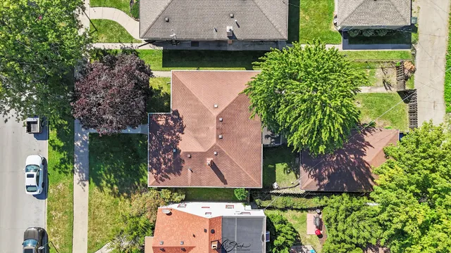 an aerial view of a house with a yard