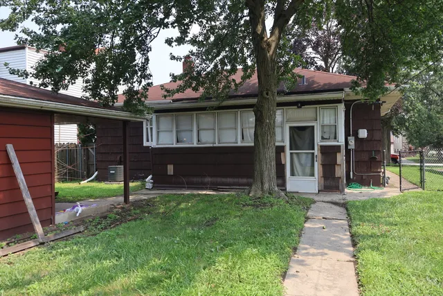 a front view of a house with a yard and porch
