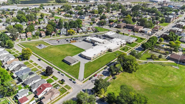 an aerial view of a house with yard swimming pool and ocean view
