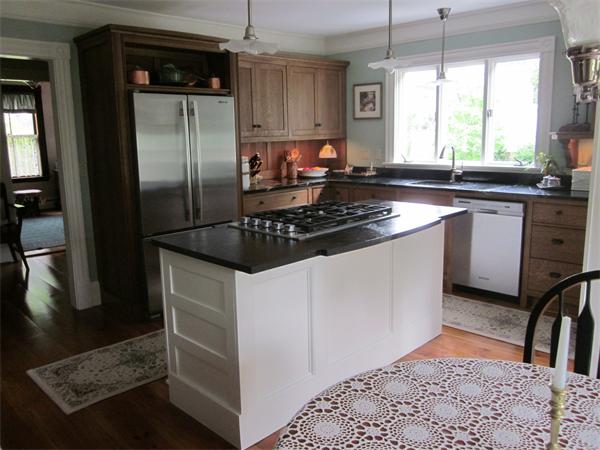 19 Putnam Road Ipswich, MA 01938 - Photo 2 of 13 a kitchen with stainless steel appliances granite countertop a refrigerator a sink a stove a dining table and chairs