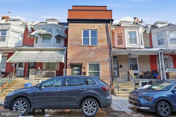 a front view of a house with parking space